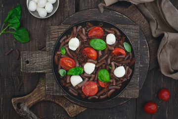 Dark brown buckwheat pasta with mozzarella