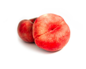 Saturn Peach isolated on white background. Flat peaches, two doughnut peaches in a pile.