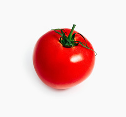 Delicious red fresh tomato with green steam, isolated on a white background.