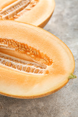 Half of ripe melon on grey table