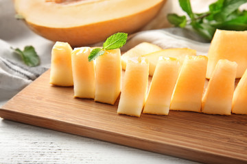 Sliced ripe melon on wooden board