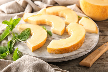 Sliced ripe melon on wooden board