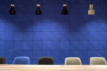 Conference room with blue wall and hanging lamps