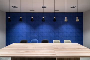 Business interior with blue wall and hanging lamps