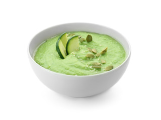 Tasty zucchini soup in bowl on white background