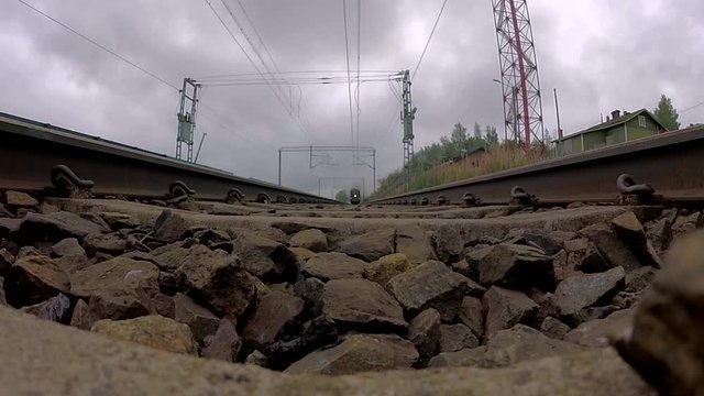 A very old steam engine train riding over a camera on tracks.