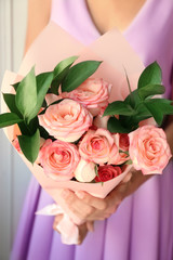 Woman holding bouquet of beautiful roses