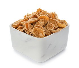 Bowl with healthy cornflakes on white background