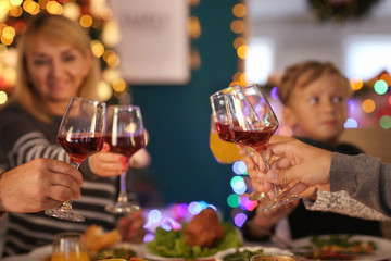 Happy family drinking wine during Christmas dinner at home