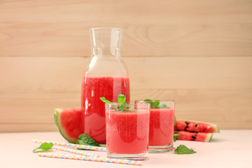 Glasses with fresh watermelon smoothie on table