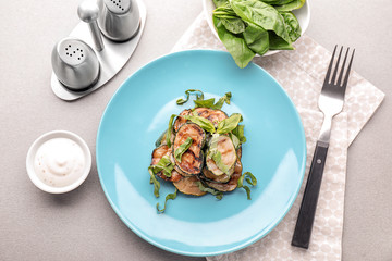 Plate with tasty grilled zucchini on light table