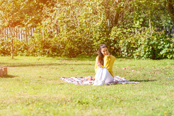 A beautiful woman eating a Apple in the Garden in Autumn	