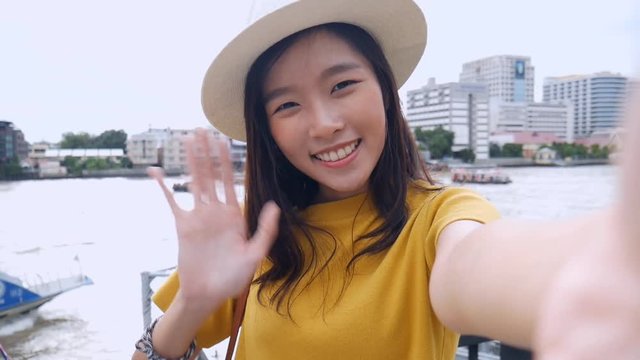 Beautiful asian woman taking selfies on a smartphone. Young asian girl tourist travel to thailand.