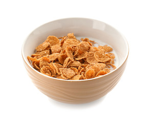 Bowl with healthy cornflakes and milk on white background