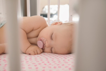 Cute little baby sleeping in crib