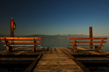 Naklejka premium Two benches on the pier, Skadarsko Jezero