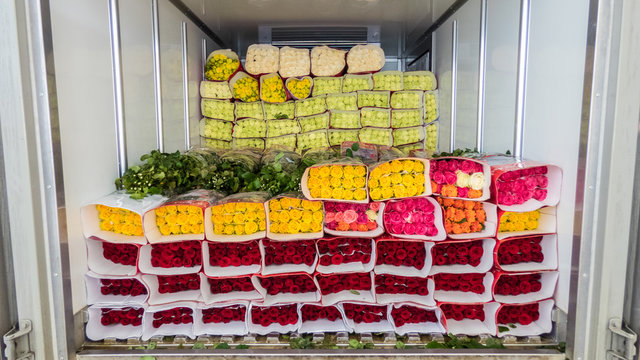 Opened Back Doors Of The Truck Loaded With Rose Flowers. Loading Flowers In Stock For Delivery.