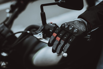 Hand In A Glove Laying On Motorcycle Steering.