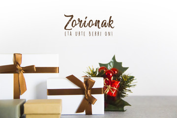 Christmas gift boxes on white background, with merry christmas text in basque language, euskera...