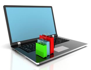 laptop and shopping pags on white background
