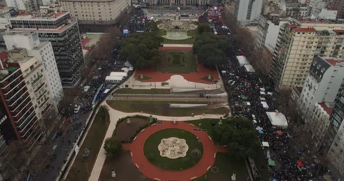 Drone view of Argentinian Congress and crowd outside , during legal abortion vote. Tilt down towards the crowd.