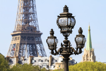 Fototapeta na wymiar Ancient ornate lantern in Paris, France, with the Eiffel tower in the background on a spring day