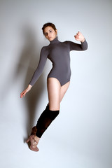 gorgeous female dancer in grey body on grey background