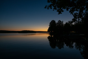 Sunset and trees reflecting from the lake