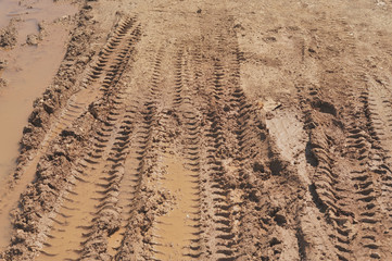 Traces of wheeled vehicles used in agriculture on a dirt road