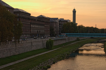 Plakat Evening scenery of Ostrava city. Ostravice river, embankment and bridge over river, residential buildings and New Town Hall in the background. Ostrava, Czech Republic