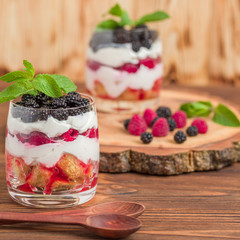 Trifle close up photography with fresh multi layered dessert with dairy and ripe raspberries and...