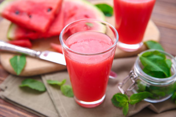 Glass with fresh watermelon smoothie on table