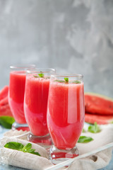 Glasses with fresh watermelon smoothie on table