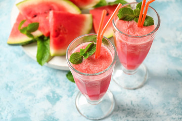 Glasses with fresh watermelon smoothie on light table