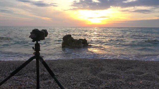 Photographer at the beach at sunset