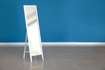 Large mirror near color wall