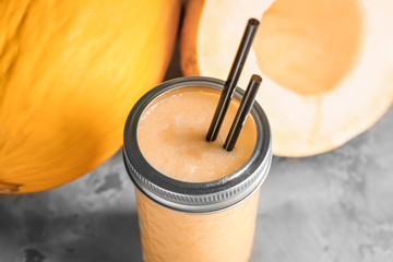 Jar of fresh melon smoothie on light table