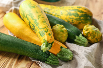 Fresh zucchinis on wooden table, closeup