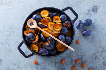 cast iron pot full of plums
