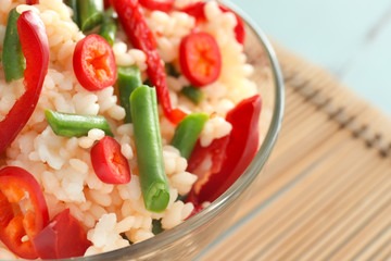 Bowl with tasty boiled rice and vegetables, closeup