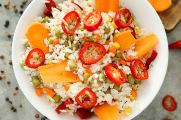 Bowl with tasty boiled rice and vegetables, closeup