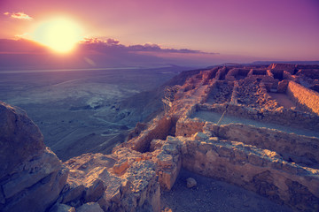 Beautiful sunrise over Masada fortress and the Judaean Desert. Ruins of King Herod's palace. Israel