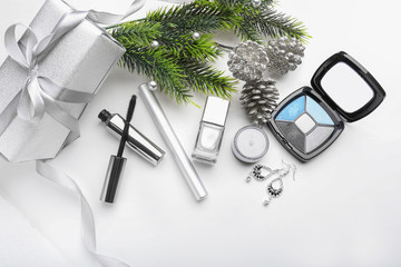 Set of cosmetics with Christmas present and decorations on white background