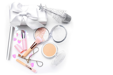 Naklejka premium Set of cosmetics with Christmas present and decorations on white background