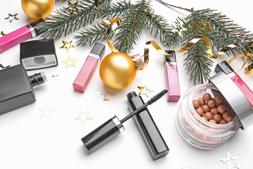 Set of cosmetics with Christmas decorations on white background