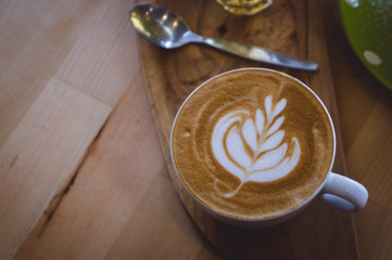 coffee hot drink cappucino latte art on wood vintage table , coffee time on wood background cafe