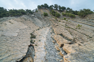 Mountain with faults after rockfall bottom view.
