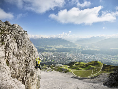 Austria, Innsbruck, Nordkette, man climbing in rock wall