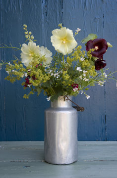 Bunch of wildflowers in milk can
