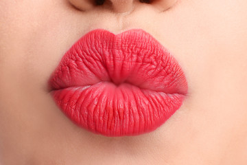 Beautiful young woman with bright red lipstick, closeup